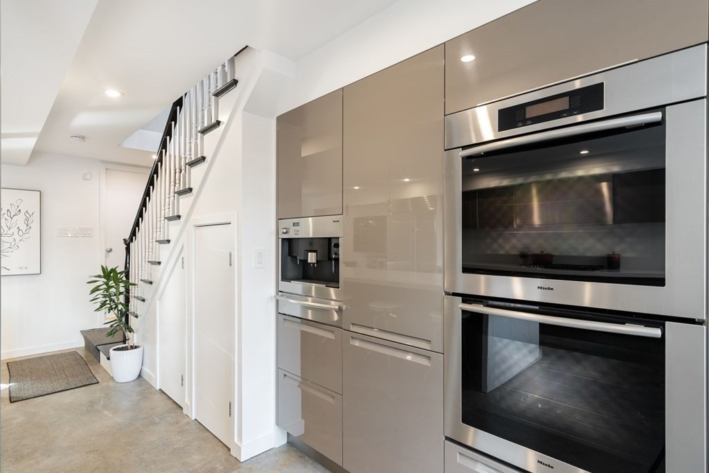 112 West 3rd Street Boston, MA 02127 - Photo 10 of 33 a kitchen with granite countertop white cabinets and stainless steel appliances