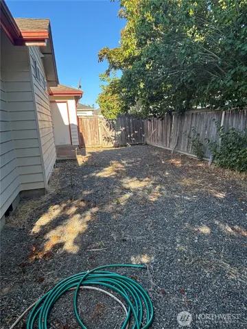 a backyard of a house with yard and outdoor seating