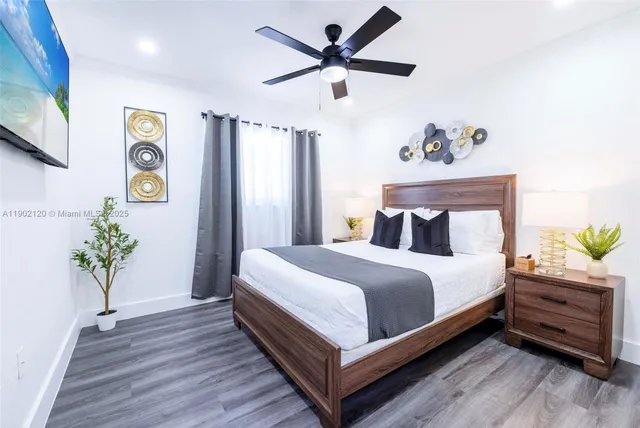 a bedroom with a bed and a potted plant