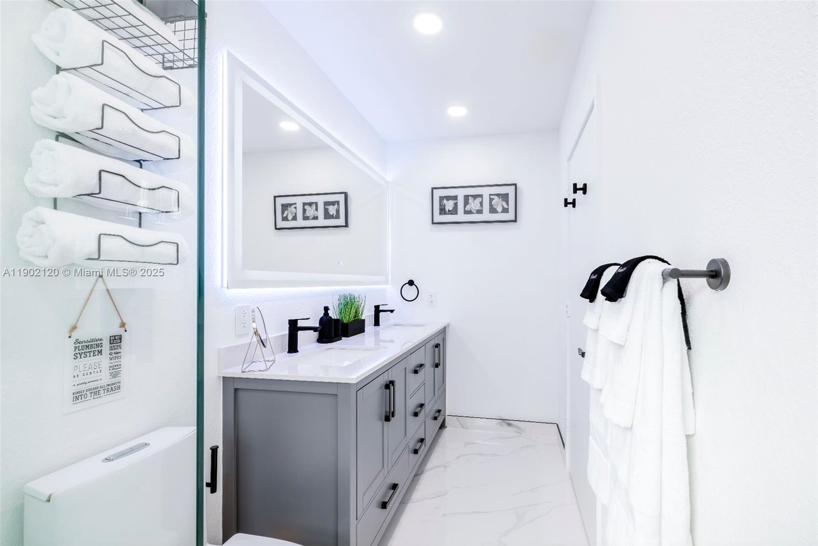 15445 Southwest 57th Street Miami, FL 33193 - Photo 18 of 32 a bathroom with a sink and a mirror