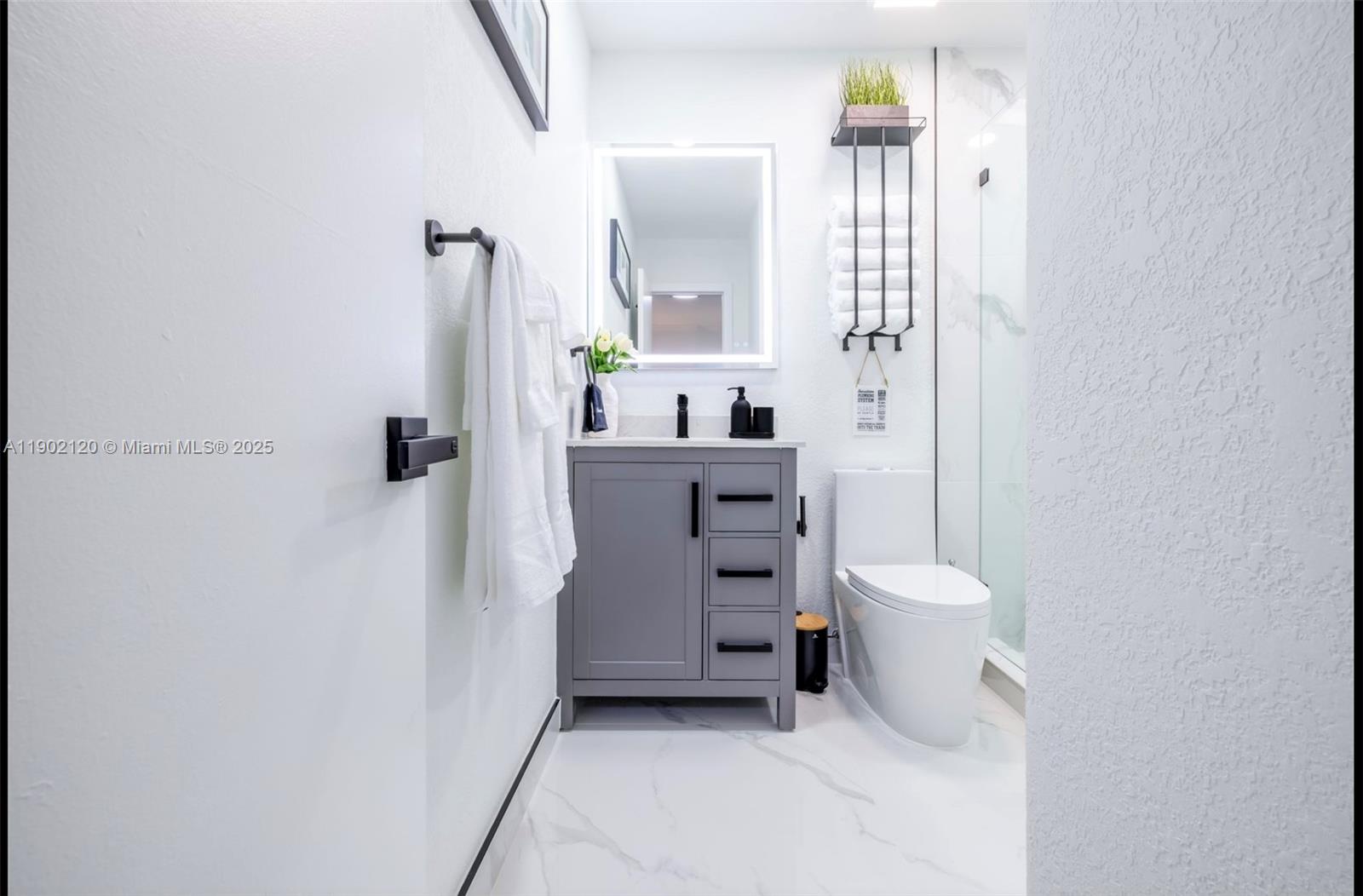 15445 Southwest 57th Street Miami, FL 33193 - Photo 20 of 32 a bathroom with a toilet sink and mirror