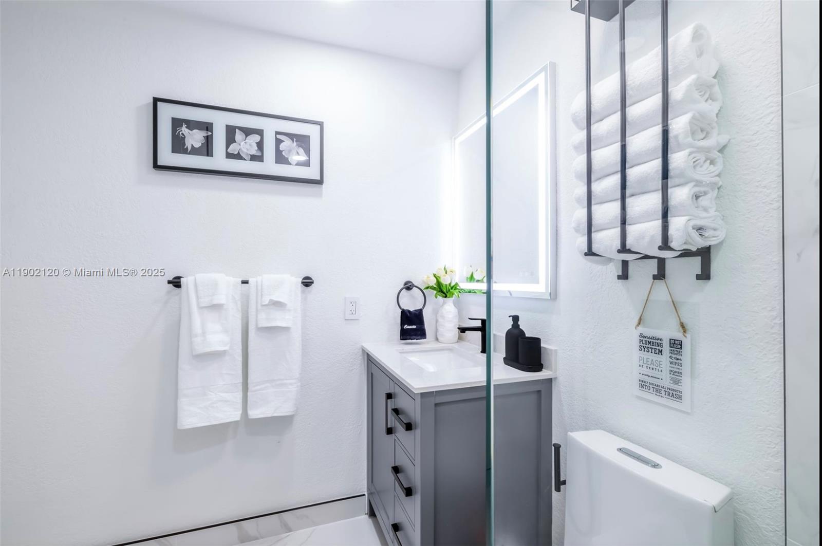 15445 Southwest 57th Street Miami, FL 33193 - Photo 21 of 32 a bathroom with a toilet sink and mirror