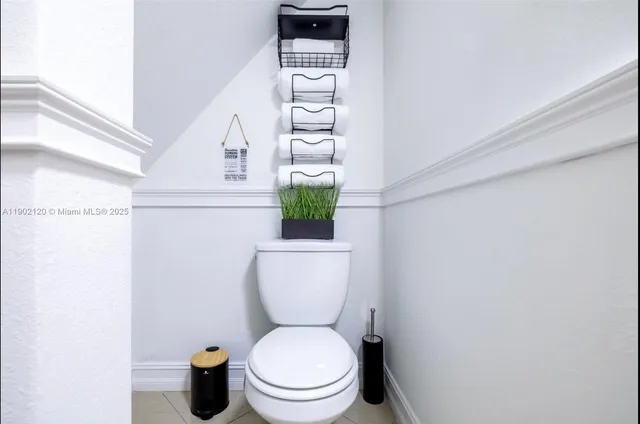 a white toilet sitting next to a shower curtain