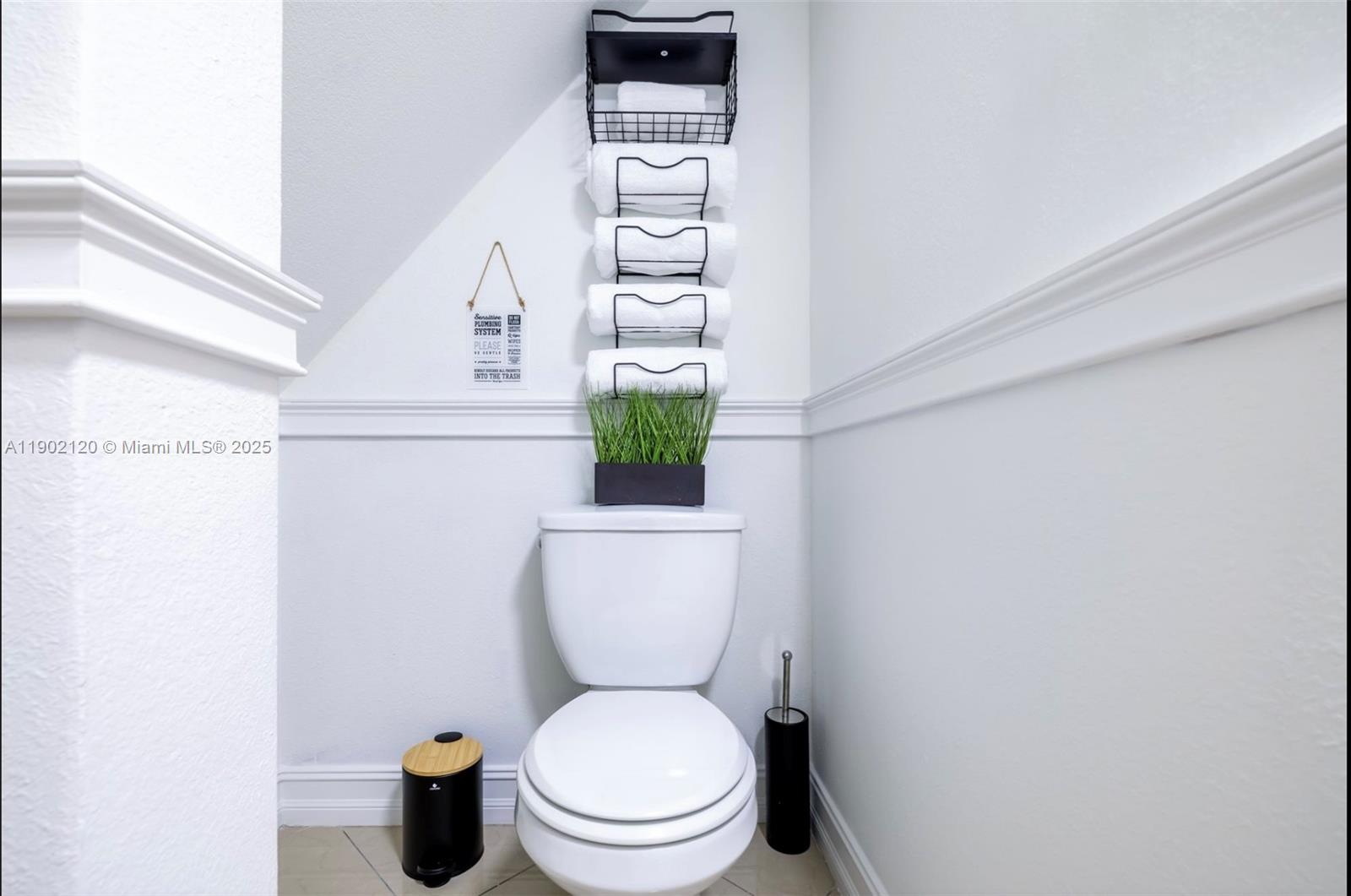 15445 Southwest 57th Street Miami, FL 33193 - Photo 25 of 32 a white toilet sitting next to a shower curtain