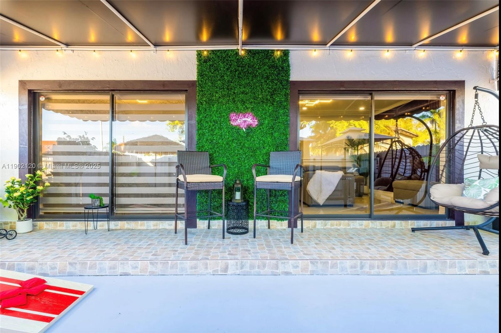15445 Southwest 57th Street Miami, FL 33193 - Photo 27 of 32 a view of a patio with table and chairs potted plants with floor to ceiling window and potted plants
