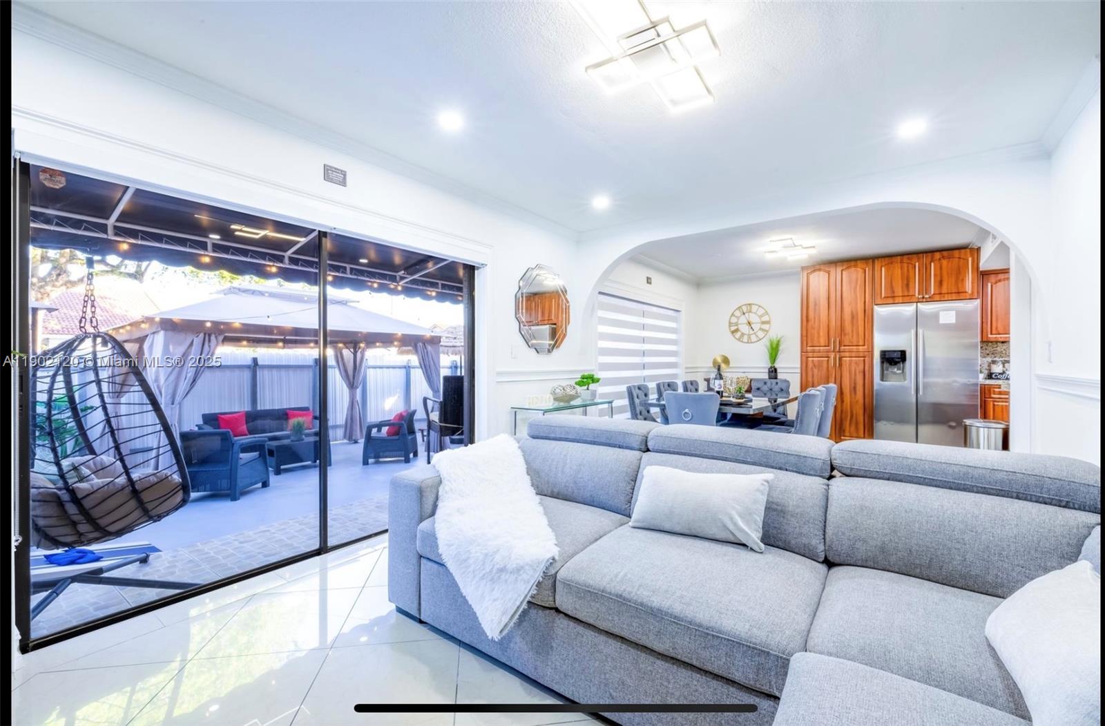 15445 Southwest 57th Street Miami, FL 33193 - Photo 3 of 32 a living room with furniture and a large window