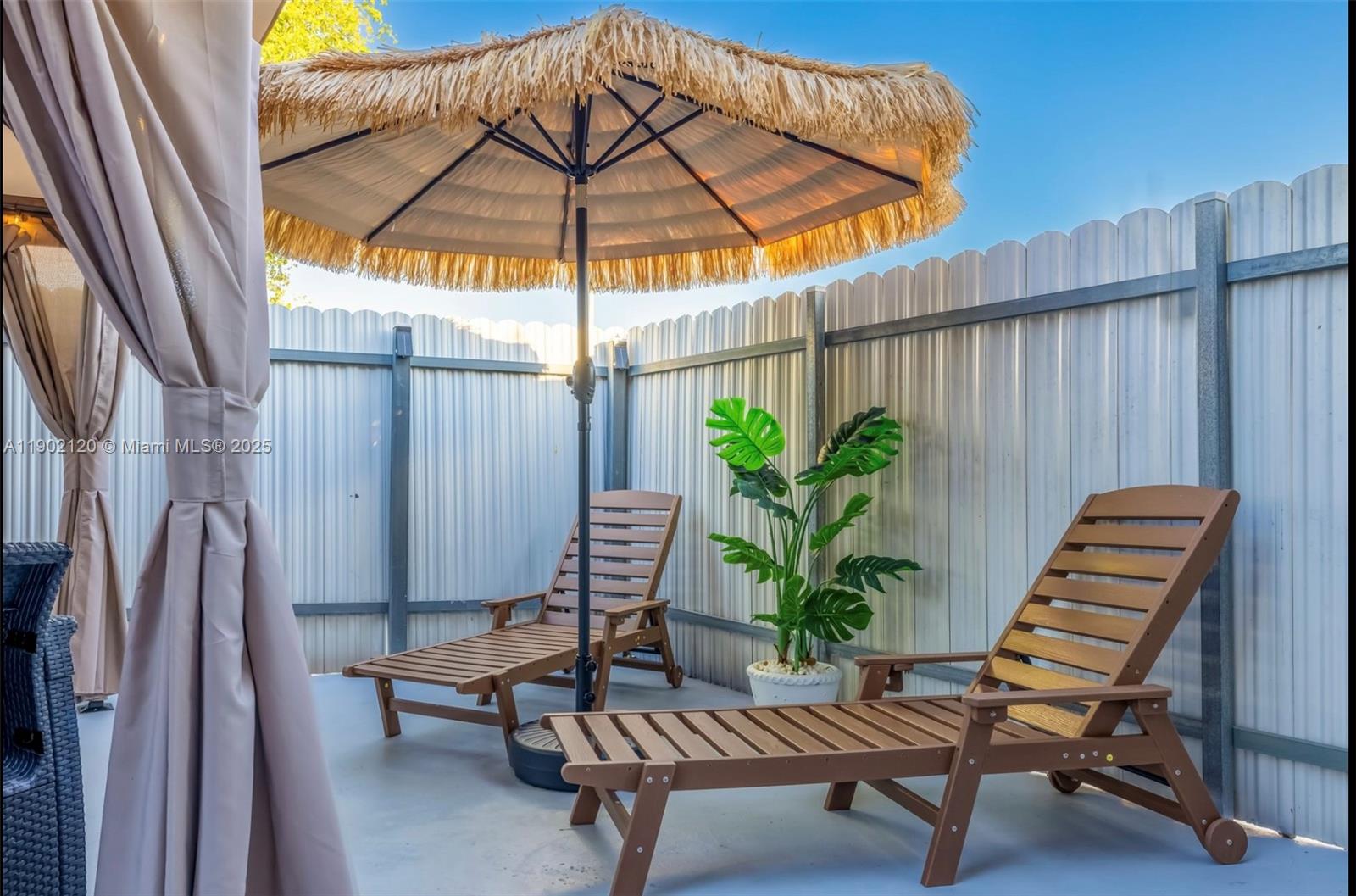 15445 Southwest 57th Street Miami, FL 33193 - Photo 31 of 32 a backyard of a house with table and chairs