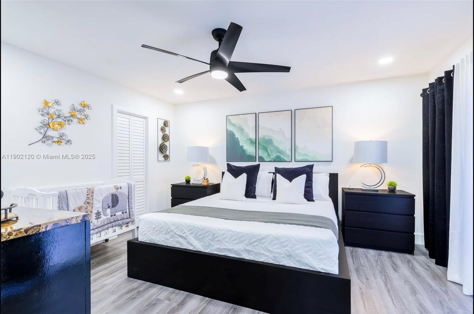 15445 Southwest 57th Street Miami, FL 33193 - Photo 10 of 32 a bed room with a bed and a chandelier