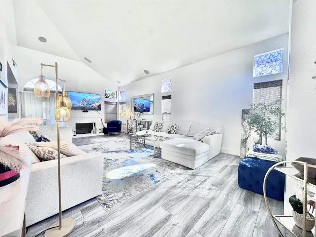 a living room with furniture and a chandelier