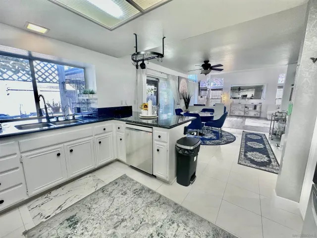 a kitchen with stainless steel appliances kitchen island granite countertop a sink stove and cabinets