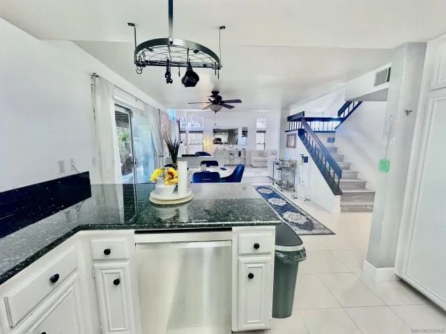 a kitchen with stainless steel appliances granite countertop a sink a stove and a refrigerator
