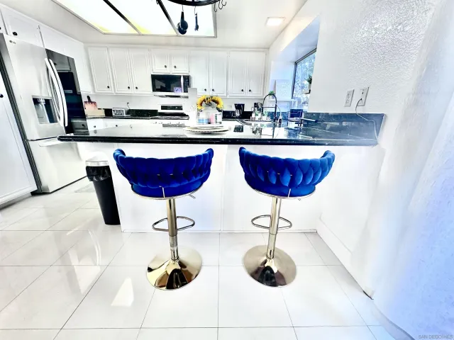 a kitchen with stainless steel appliances granite countertop a sink and cabinets