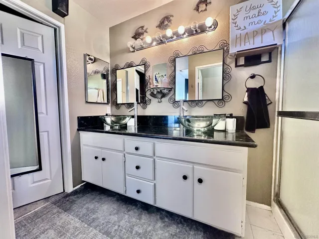 a bathroom with a sink vanity and mirror