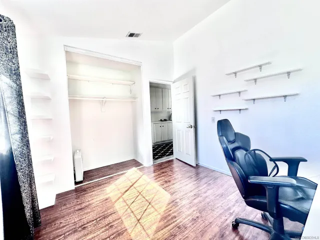 a bedroom with a bed and a chair