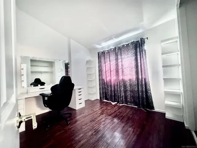 a living room with furniture window and wooden floor