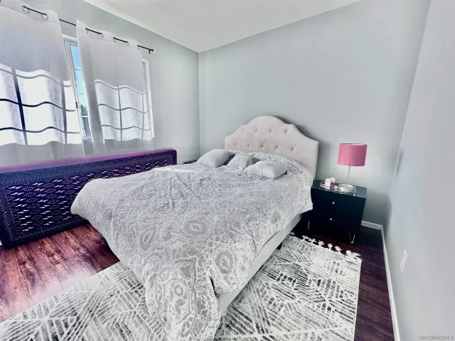 a bed sitting in a bedroom next to a window