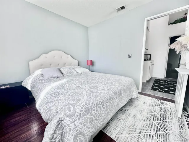 a bedroom with a bed and a mirror