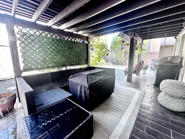 a living room with furniture and a floor to ceiling window