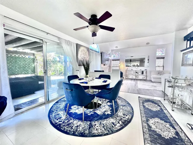 a living room with furniture a table and a large window