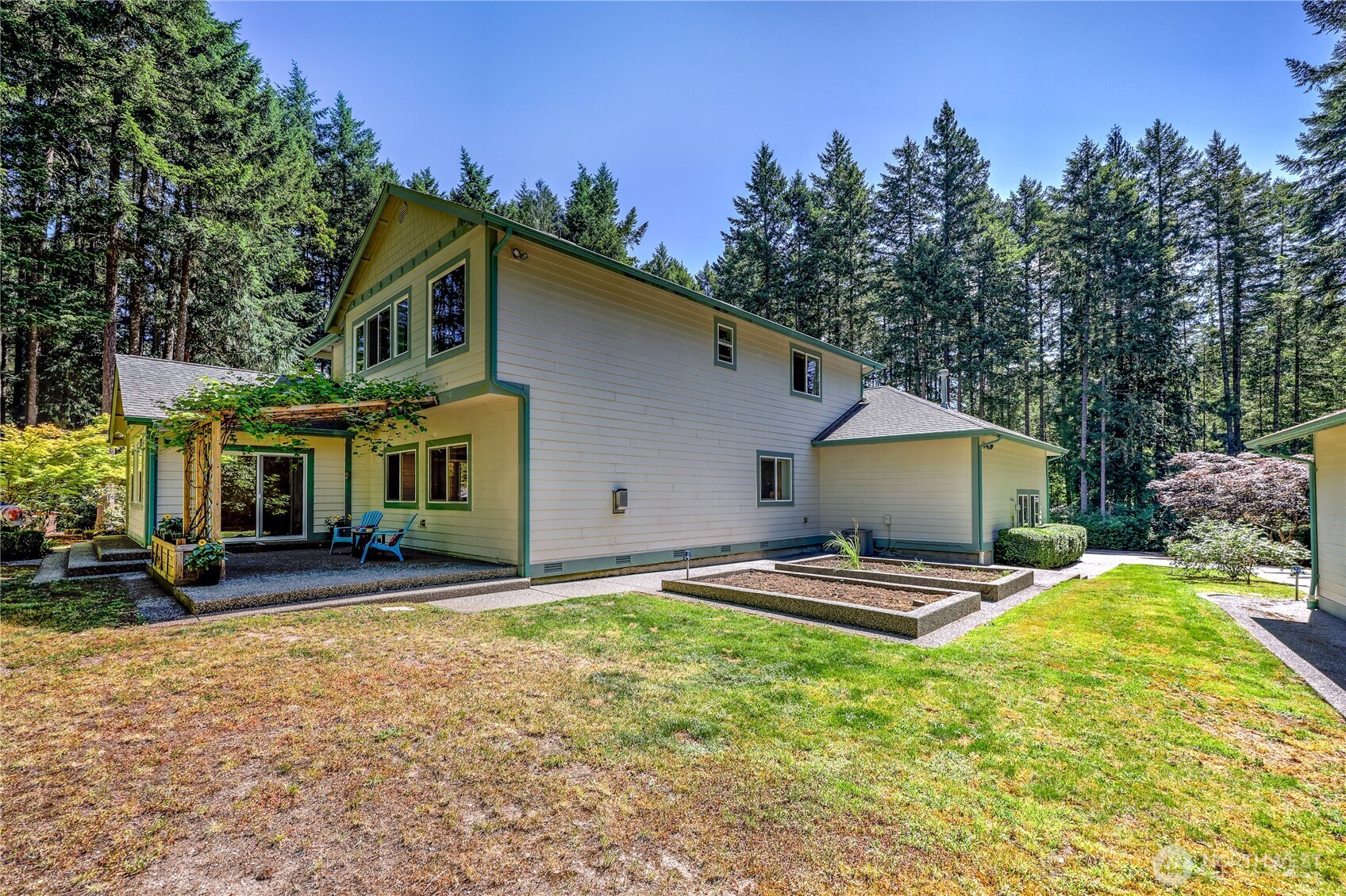 4354 Northwest Westgate Road Silverdale, WA 98383 - Photo 31 of 40 a front view of a house with a yard and trees