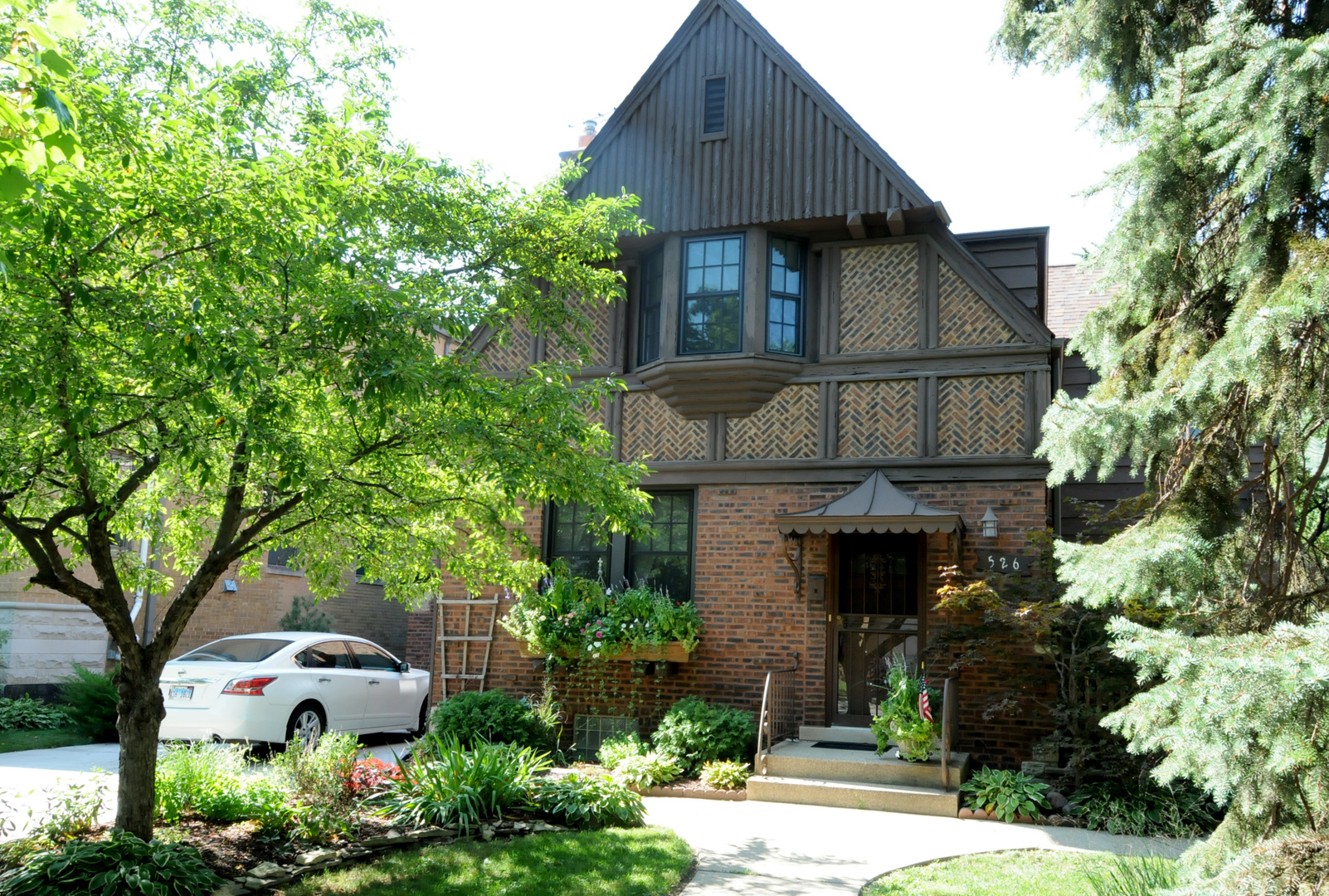 526 Longcommon Road Riverside, IL 60546 - Photo 1 of 40 a front view of a house with garden