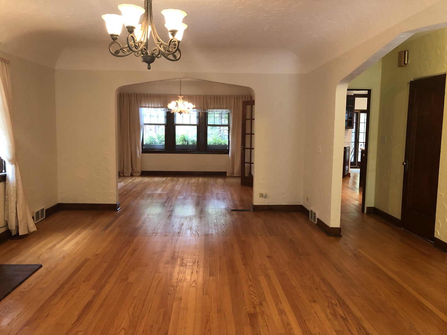 526 Longcommon Road Riverside, IL 60546 - Photo 12 of 40 an empty room with wooden floor chandelier and windows