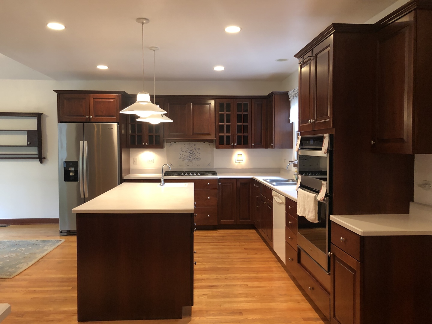 526 Longcommon Road Riverside, IL 60546 - Photo 3 of 40 a kitchen with stainless steel appliances kitchen island granite countertop a refrigerator and a sink