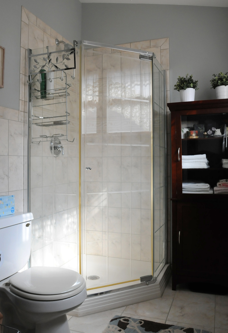 526 Longcommon Road Riverside, IL 60546 - Photo 21 of 40 a bathroom with a glass shower door and a sink