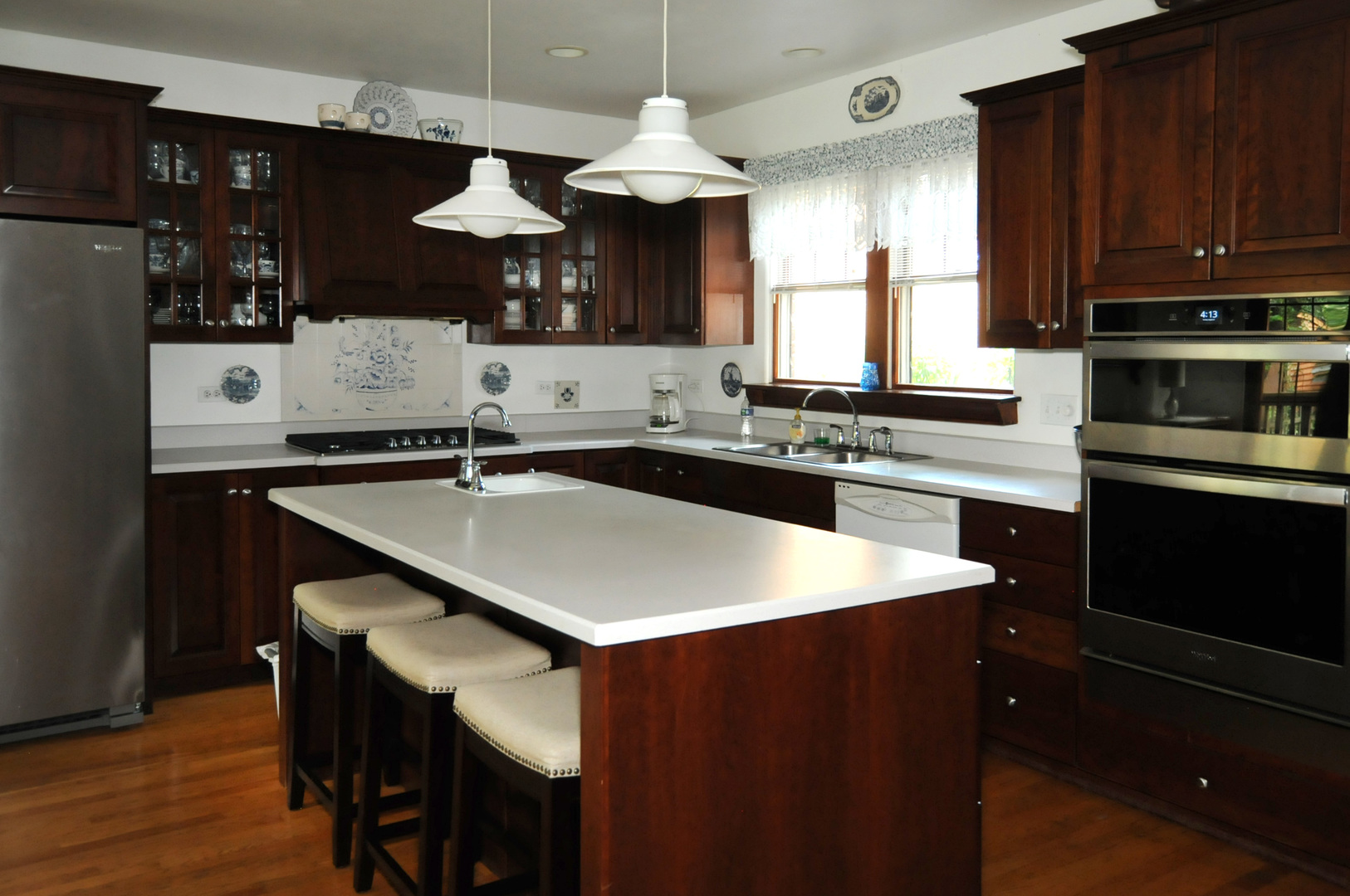 526 Longcommon Road Riverside, IL 60546 - Photo 6 of 40 a kitchen with stainless steel appliances a sink a stove a refrigerator and cabinets