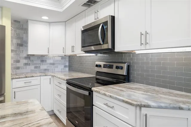 a kitchen with a sink dining table and chairs