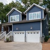 a view of a house with large windows and a small yard