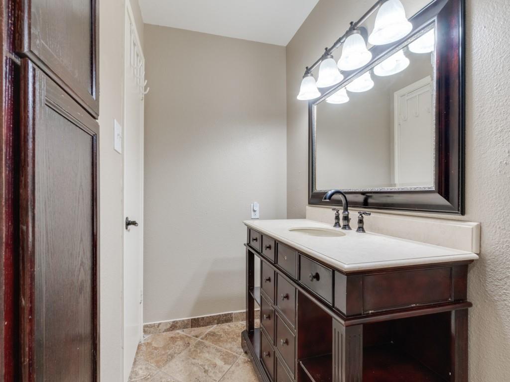 4221 Cole Avenue, Unit 103 Dallas, TX 75205 - Photo 11 of 17 a bathroom with a sink and a mirror