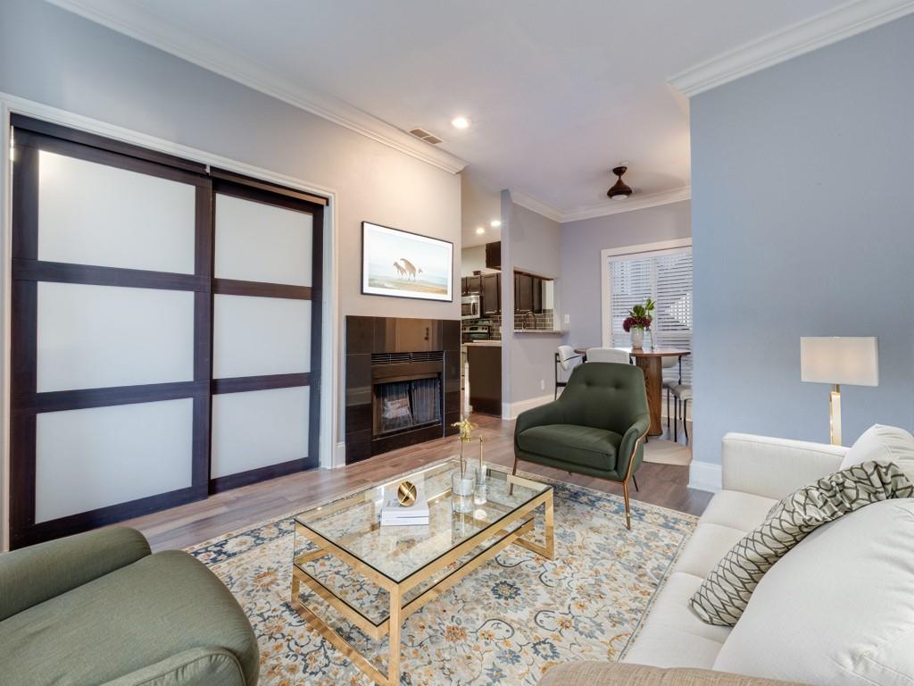 4221 Cole Avenue, Unit 103 Dallas, TX 75205 - Photo 3 of 17 a living room with furniture a rug and a fireplace