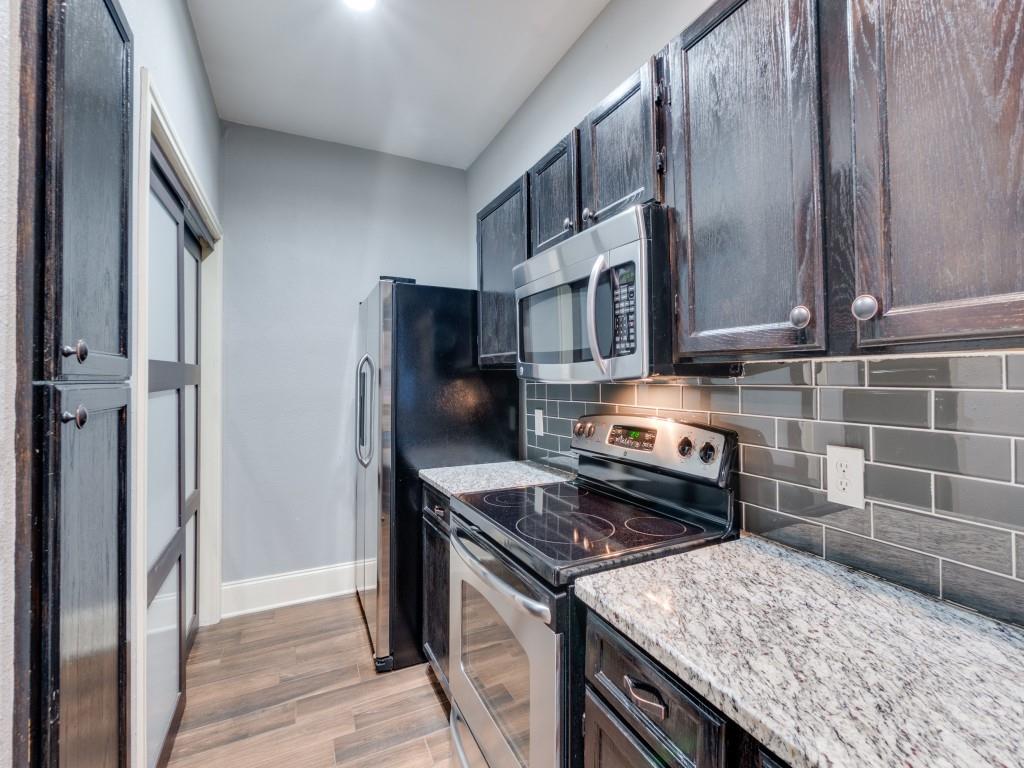 4221 Cole Avenue, Unit 103 Dallas, TX 75205 - Photo 6 of 17 a kitchen with a stove microwave and refrigerator