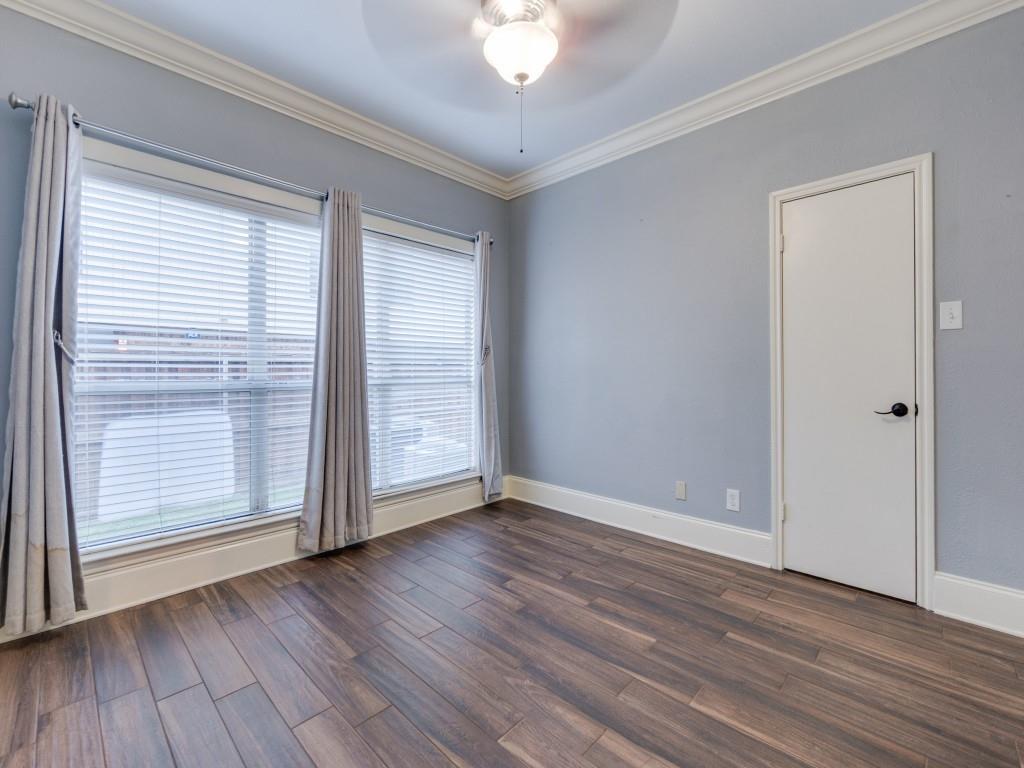4221 Cole Avenue, Unit 103 Dallas, TX 75205 - Photo 8 of 17 a view of an empty room with wooden floor and a window