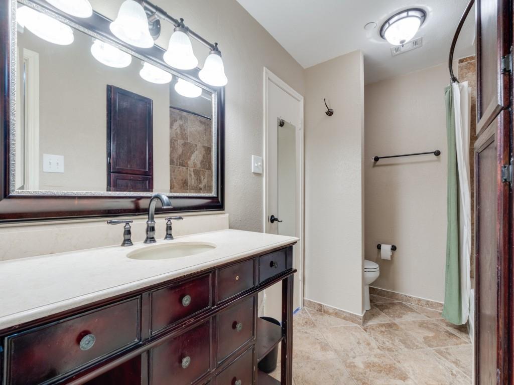 4221 Cole Avenue, Unit 103 Dallas, TX 75205 - Photo 10 of 17 a bathroom with a sink and a mirror