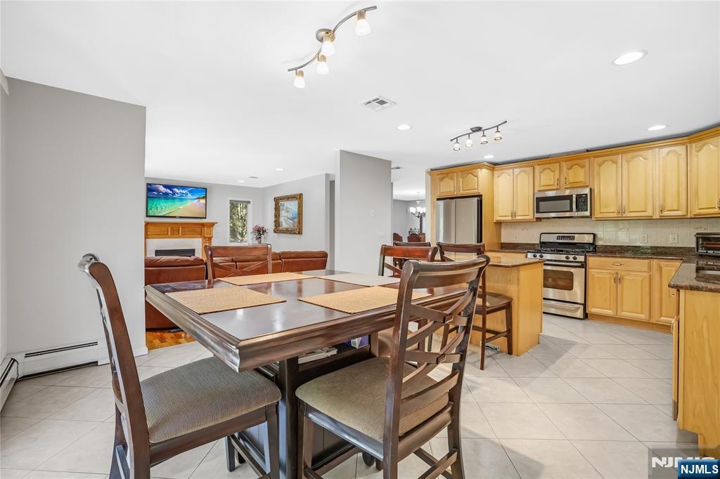 4 Maple Avenue Waldwick, NJ 07463 - Photo 13 of 34 a kitchen with a table chairs stove and cabinets