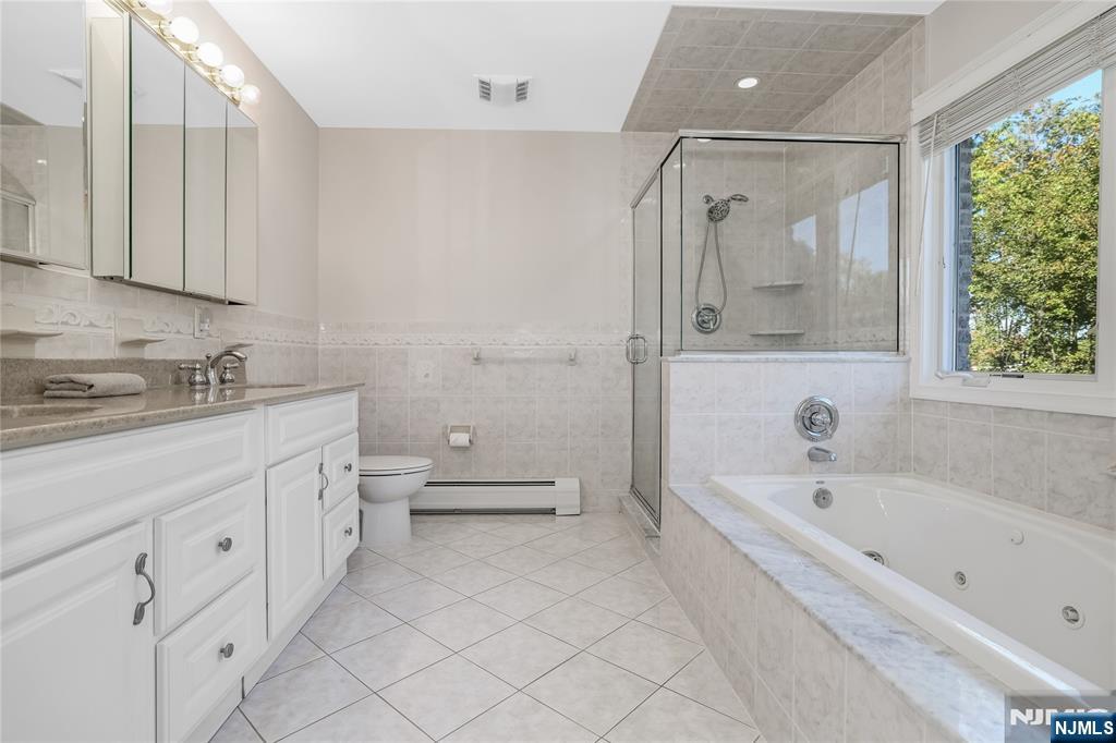 4 Maple Avenue Waldwick, NJ 07463 - Photo 18 of 34 a spacious bathroom with a tub sink and mirror