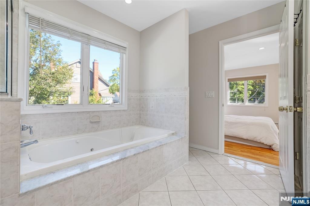 4 Maple Avenue Waldwick, NJ 07463 - Photo 19 of 34 a bathroom with a bathtub and a shower