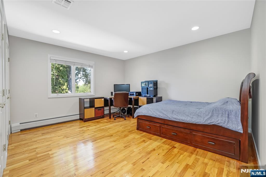 4 Maple Avenue Waldwick, NJ 07463 - Photo 22 of 34 a bedroom with a bed a table and chair
