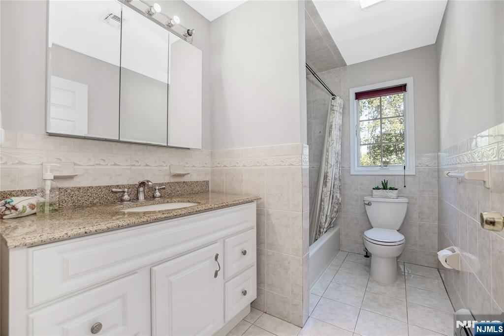 4 Maple Avenue Waldwick, NJ 07463 - Photo 23 of 34 a bathroom with a granite countertop toilet sink and mirror
