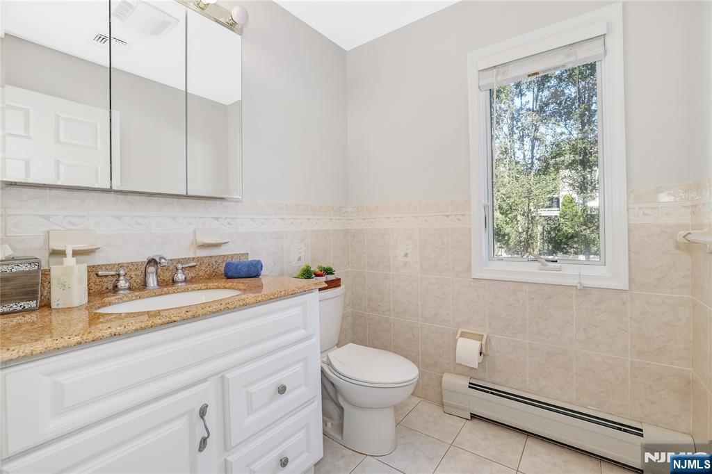 4 Maple Avenue Waldwick, NJ 07463 - Photo 24 of 34 a bathroom with a sink a toilet and a window
