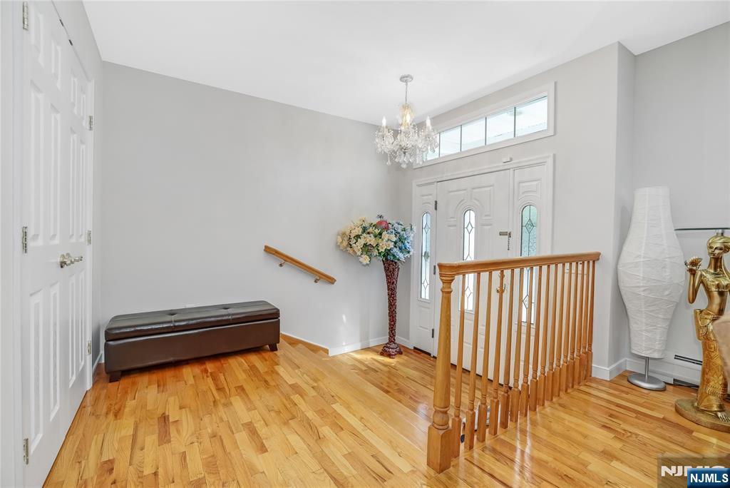 4 Maple Avenue Waldwick, NJ 07463 - Photo 6 of 34 a bedroom with a bed and a chandelier