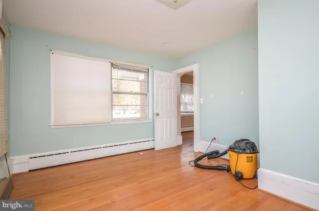 a view of a kitchen with white cabinets and white appliances