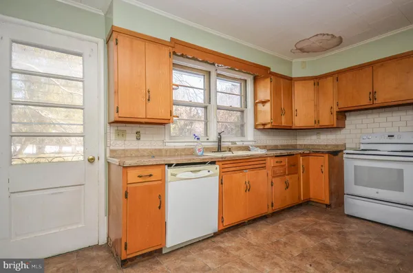 a bathroom with a toilet a sink and a mirror