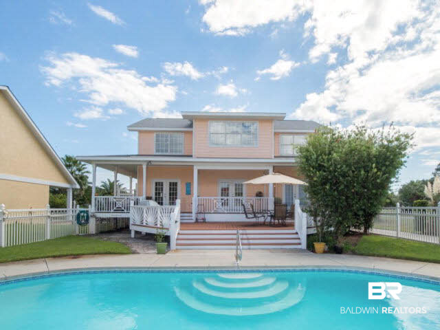 26595 Marina Road Orange Beach, AL 36561 - Photo 3 of 29 Gunite pool has new pump and polaris. two tiered deck and porch makes ample party room around the pool. Grealt room has two french doors opening on to the pool area
