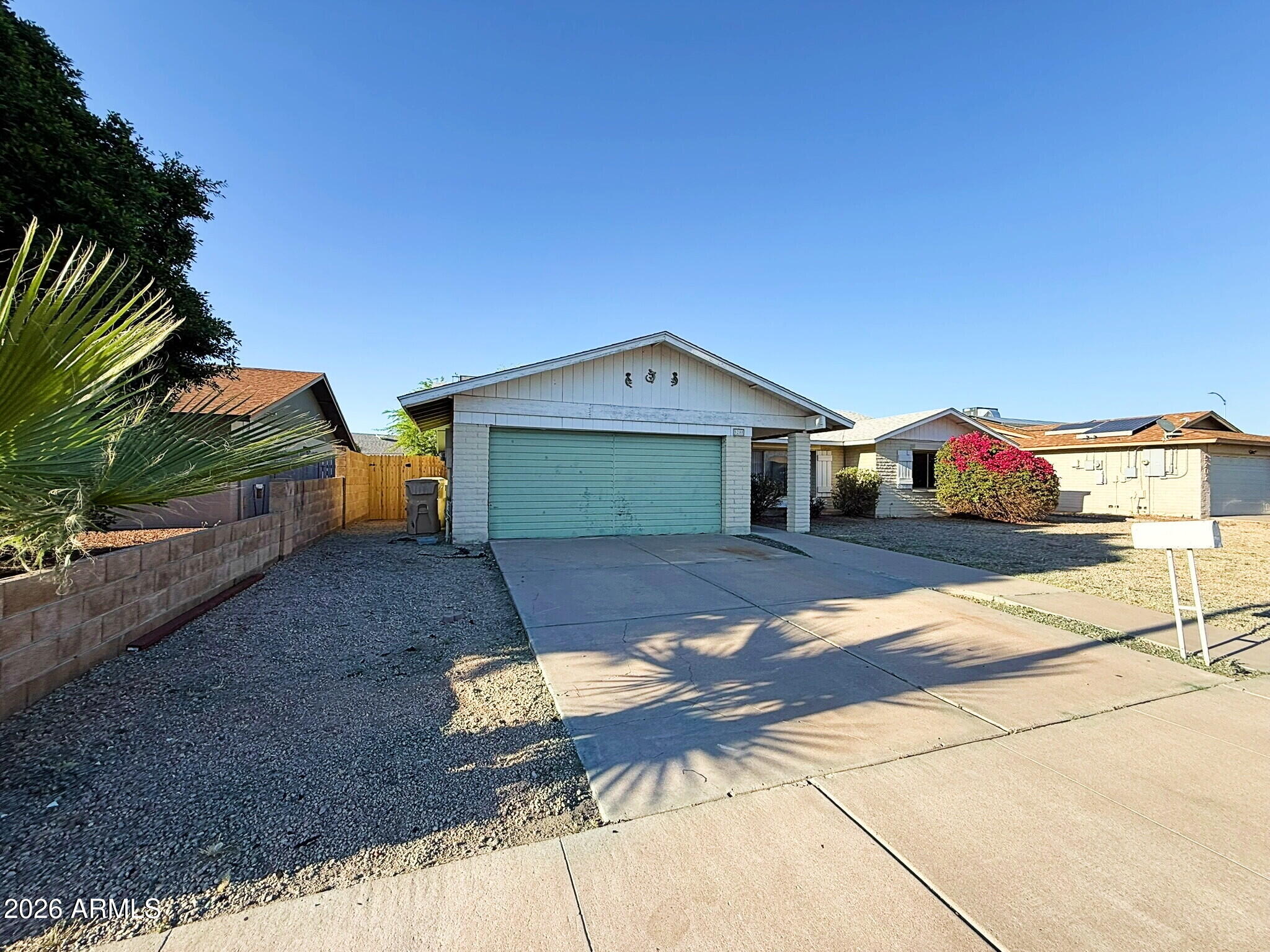 5208 West Calavar Road Glendale, AZ 85306 - Photo 26 of 39 a front view of a house with a yard