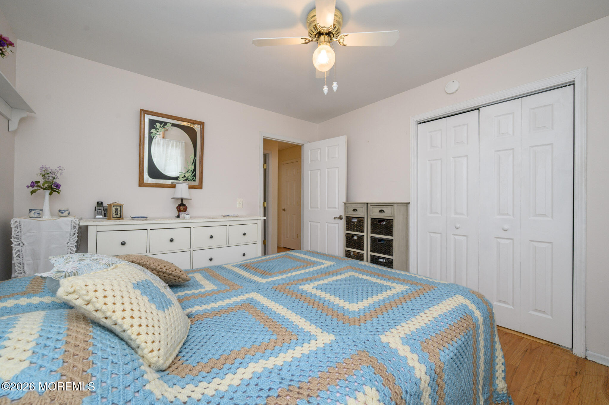96 Cooper Boulevard Red Bank, NJ 07701 - Photo 13 of 26 a bedroom with a large bed and a chandelier
