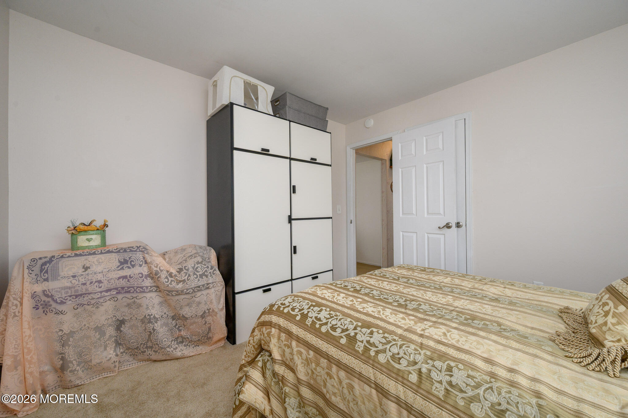 96 Cooper Boulevard Red Bank, NJ 07701 - Photo 17 of 26 a bedroom with a bed and a refrigerator
