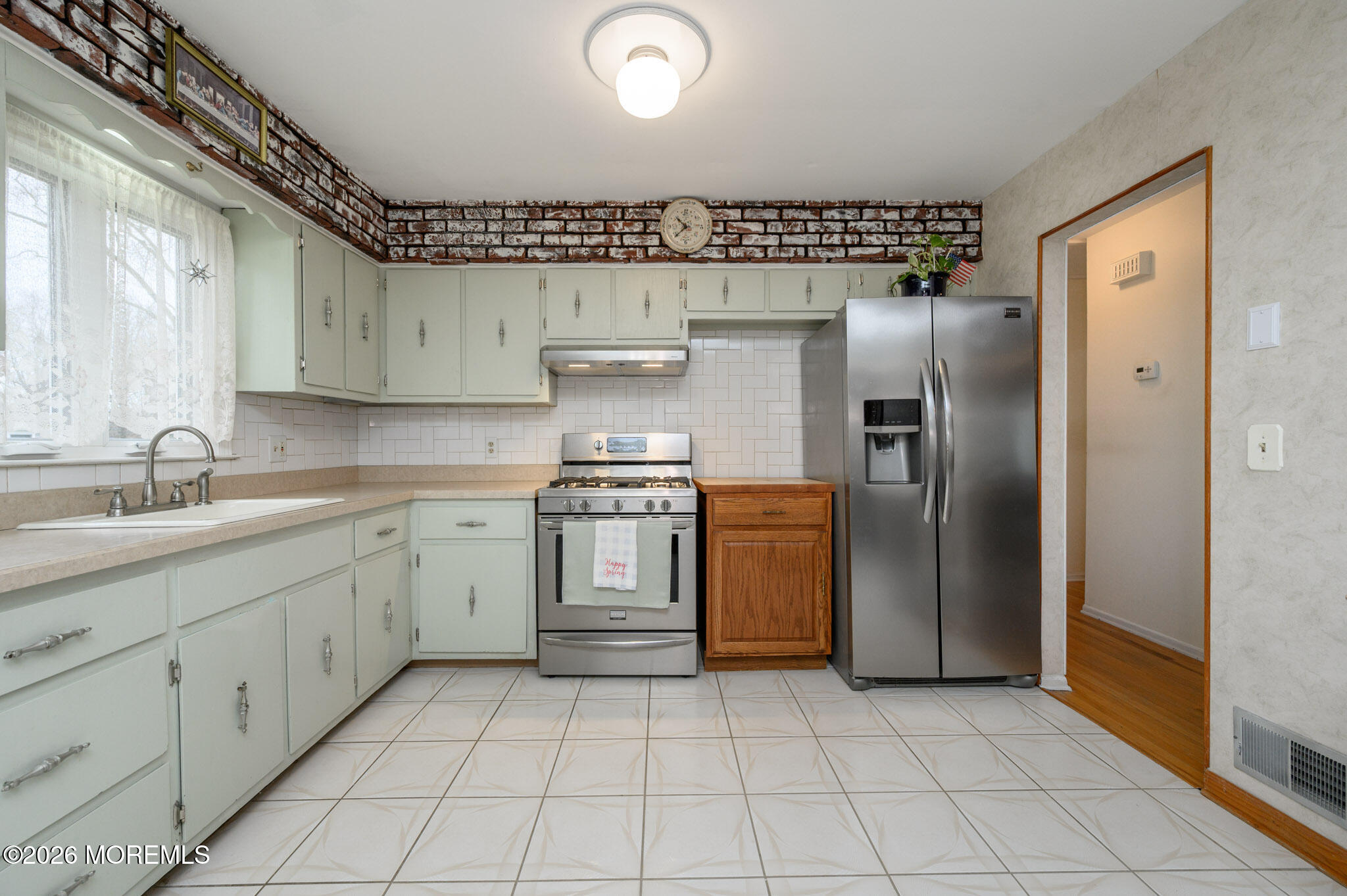 96 Cooper Boulevard Red Bank, NJ 07701 - Photo 8 of 26 a kitchen with white cabinets a sink and stainless steel appliances